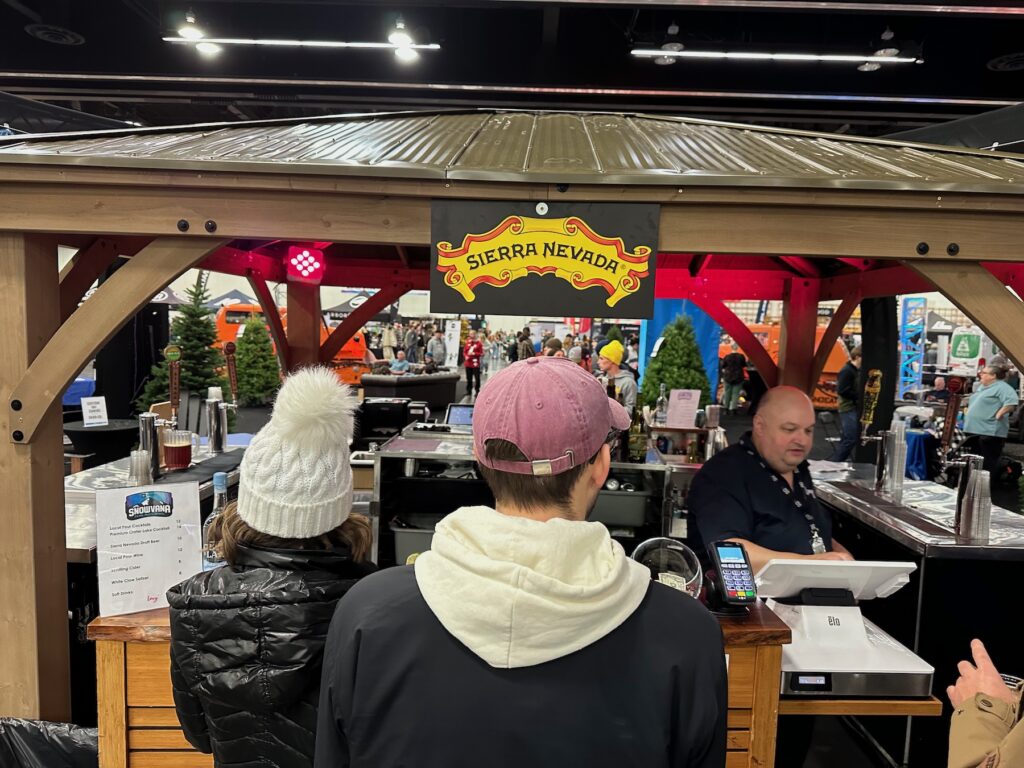 a couple ordering drinks at the Sierra Nevada bar at Snowvana